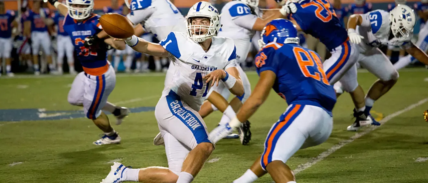 U N E football player catching the ball during a game